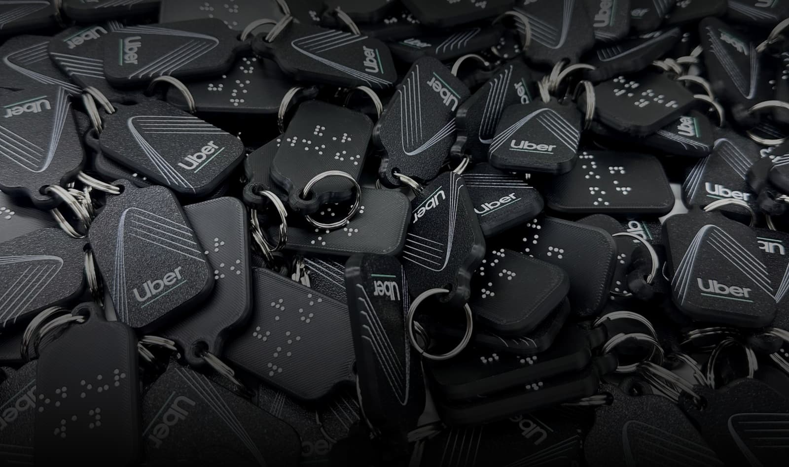 Keychains with braille text made by Miloh for Uber